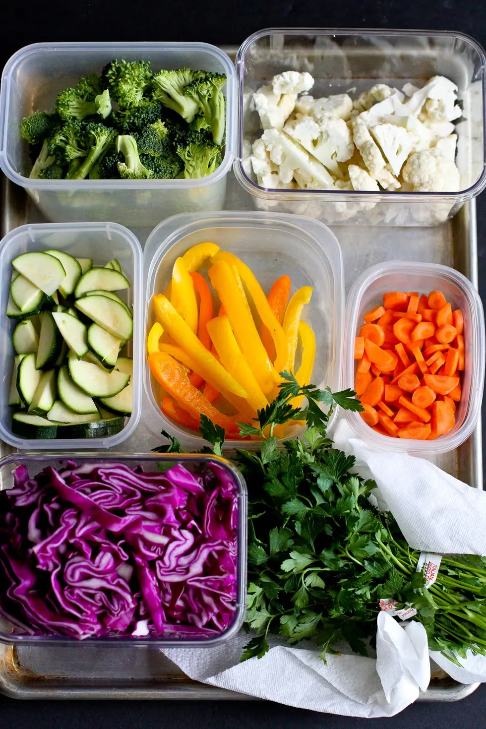 Colourful vegetables and whole grains arranged on a kitchen counter ready for weekly meal preparation